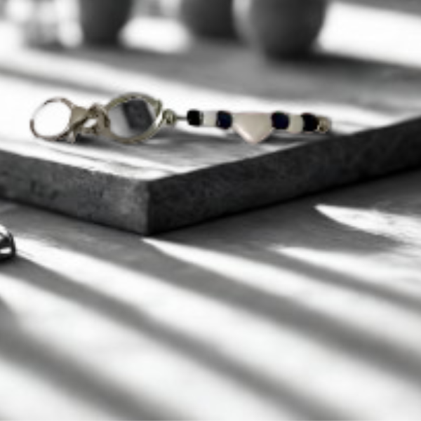 Today’s Hobbies handmade beaded keychain with white and black beads on stone surface with shadow