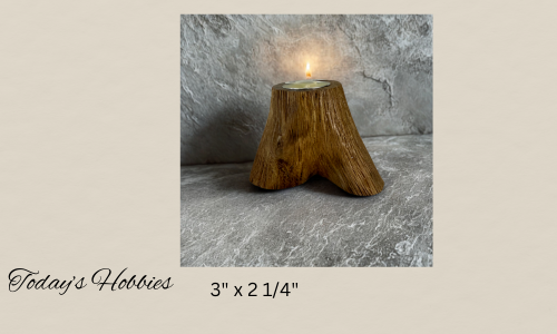 Wooden handmade candle holder for home decor shaped like a tree stump with a lit tealight candle