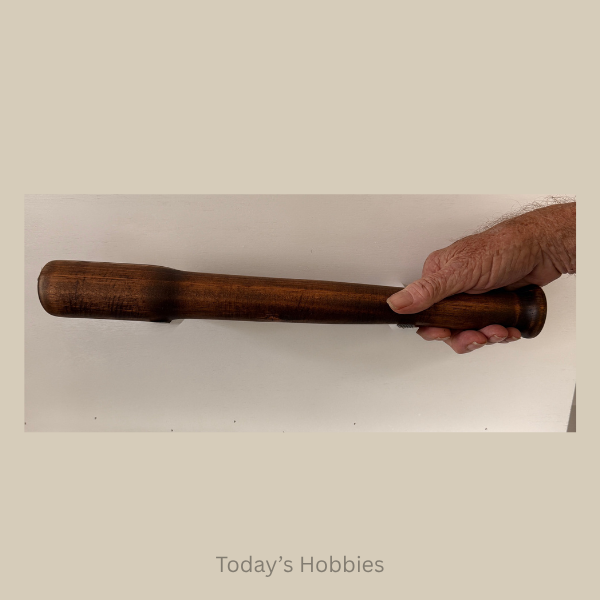 Hand holding a dark wood rod from Todays Hobbies, unique home decor accents for rustic interiors