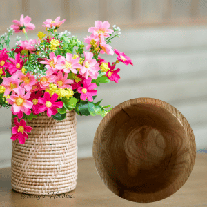 Handmade small oak bowl by Today’s Hobbies next to a wicker vase with pink and yellow flowers