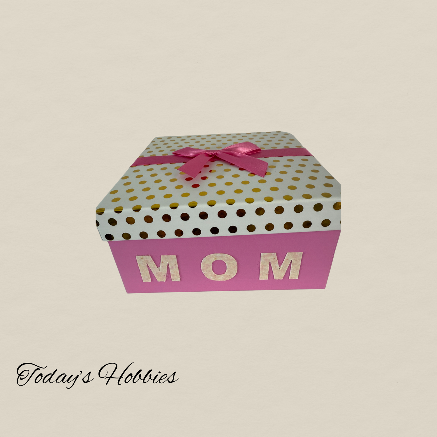 Gift box labeled MOM in pink and white with gold dots showcasing creative home decor gifts