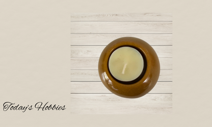 Round artistic resin home decor candle holder in brown on white wooden background