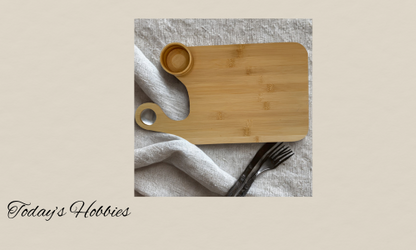 Today's Hobbies bamboo charcuterie board with salsa cup and wooden texture on fabric background