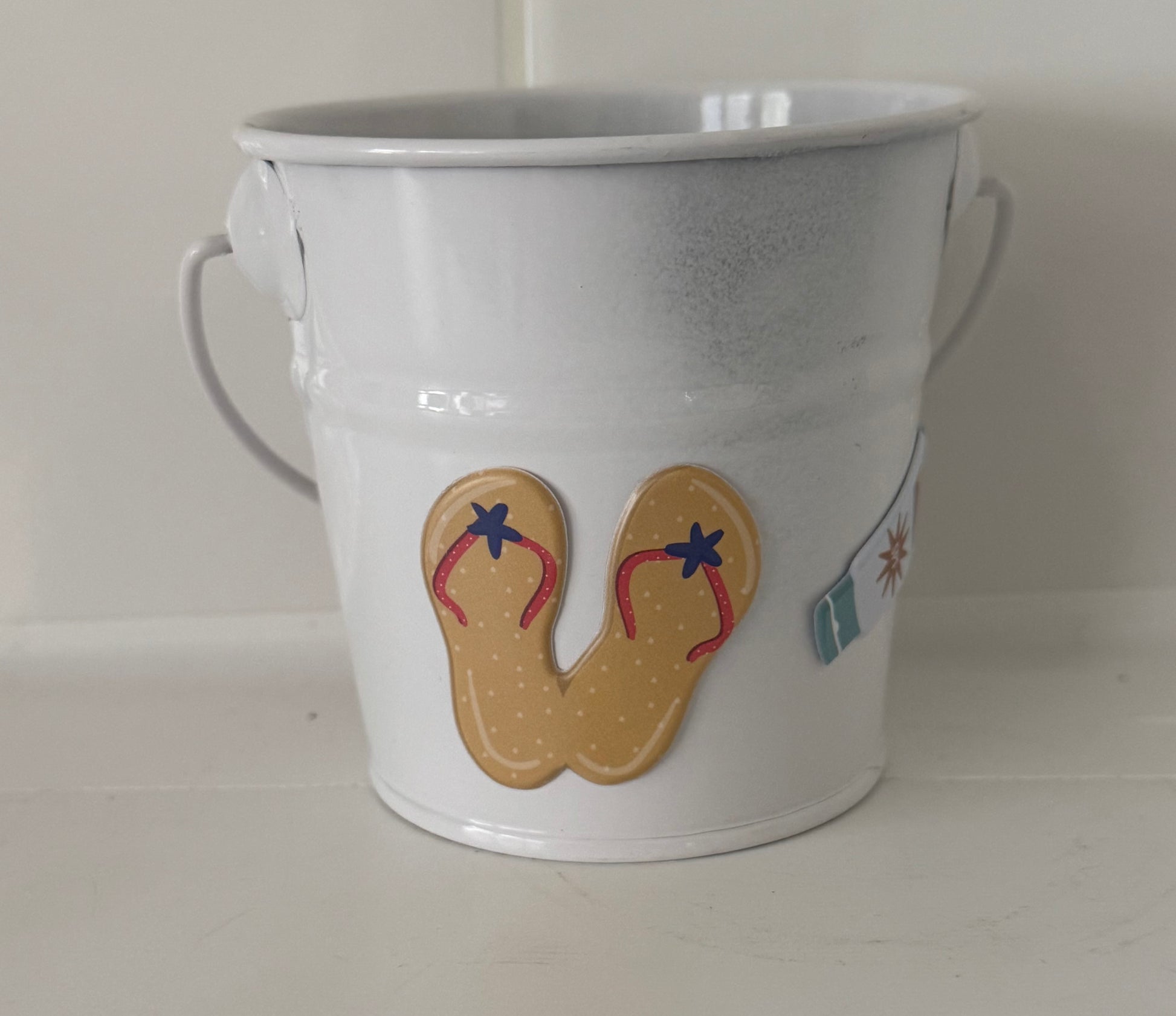 White tin from Today’s Hobbies with flip-flop and surfboard design, part of handcrafted home organizer set