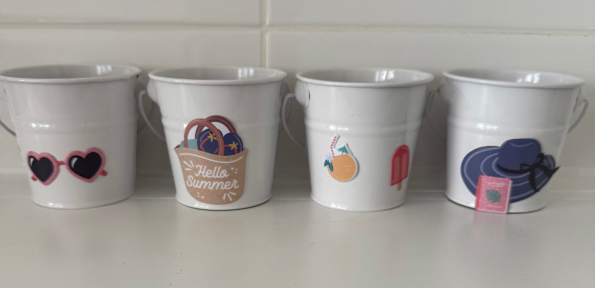Today’s Hobbies tin set featuring four white tins with summer-themed designs handcrafted home organizer set