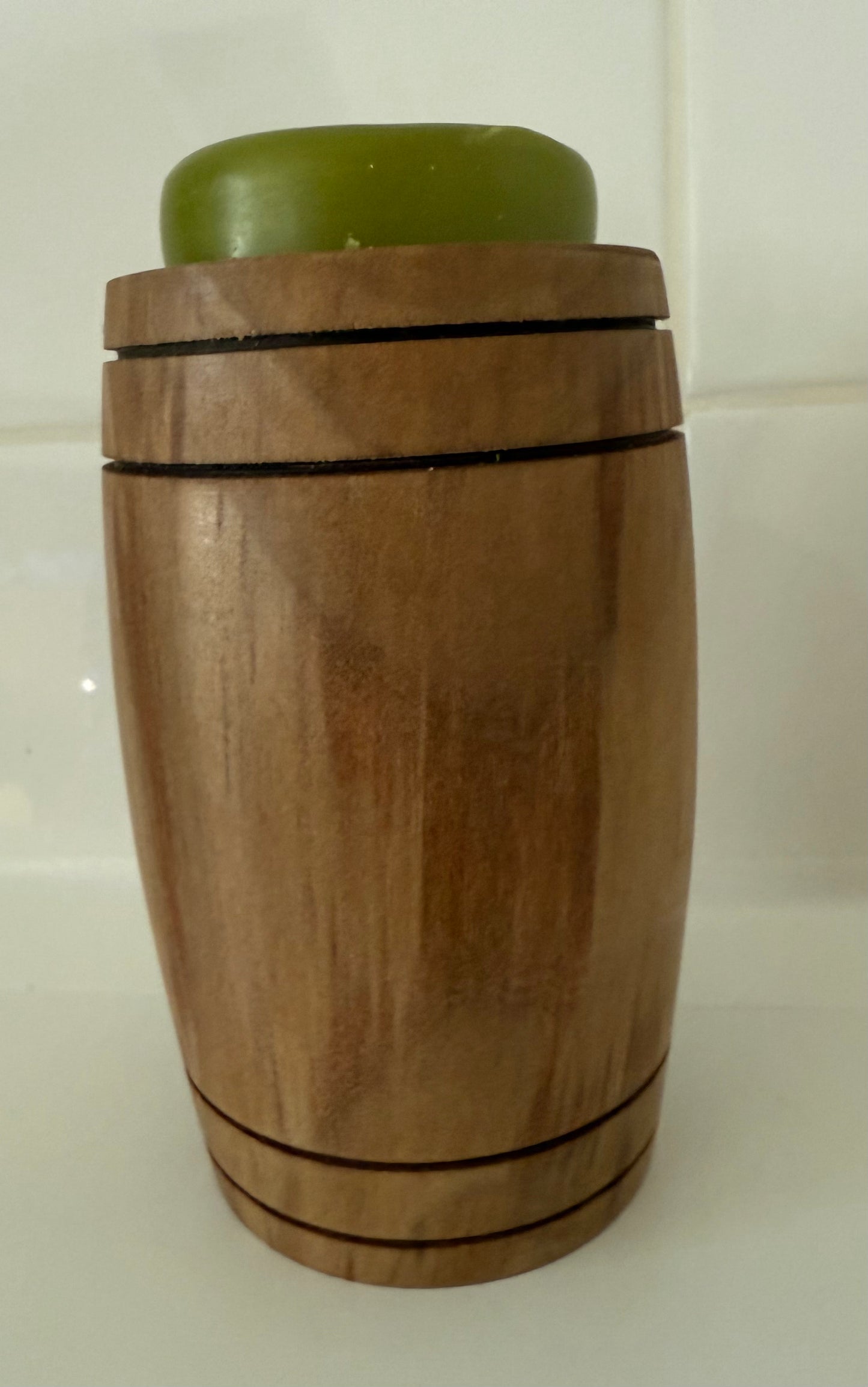 Handcrafted wooden home decor soap holder with natural wood finish and green soap on top