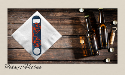 Durable steel bottle opener with sublimation design on wooden table alongside opened beer bottles