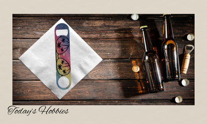 Colorful sublimation durable steel bottle opener with palm tree design on white napkin next to beer bottles