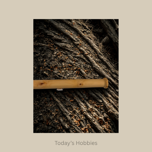 Handcrafted wooden baton by Todays Hobbies placed on textured tree bark background