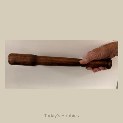Hand holding a dark wood rod from Todays Hobbies, unique home decor accents for rustic interiors