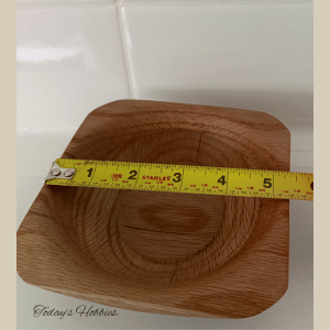 Handmade small oak bowl by Today’s Hobbies with measuring tape showing size around five inches