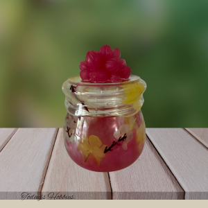 Small floral topped handmade resin keepsake jar from Todays Hobbies with pink and yellow swirls
