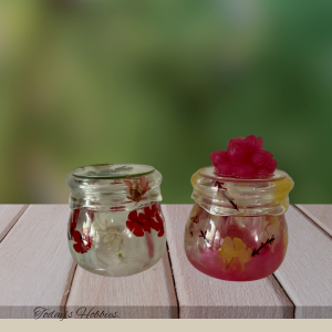 Two small floral decorative jars with preserved flowers by Todays Hobbies handmade resin keepsake jar