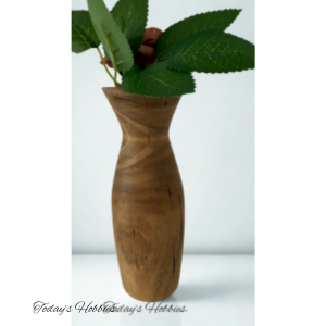 Elegant wooden vase for home decor by Today's Hobbies with natural wood grain and green leaves
